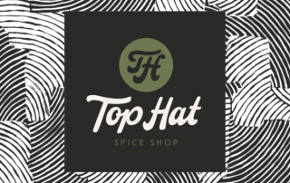 Top Hat Spice Shop logo set against a black and white abstract background.